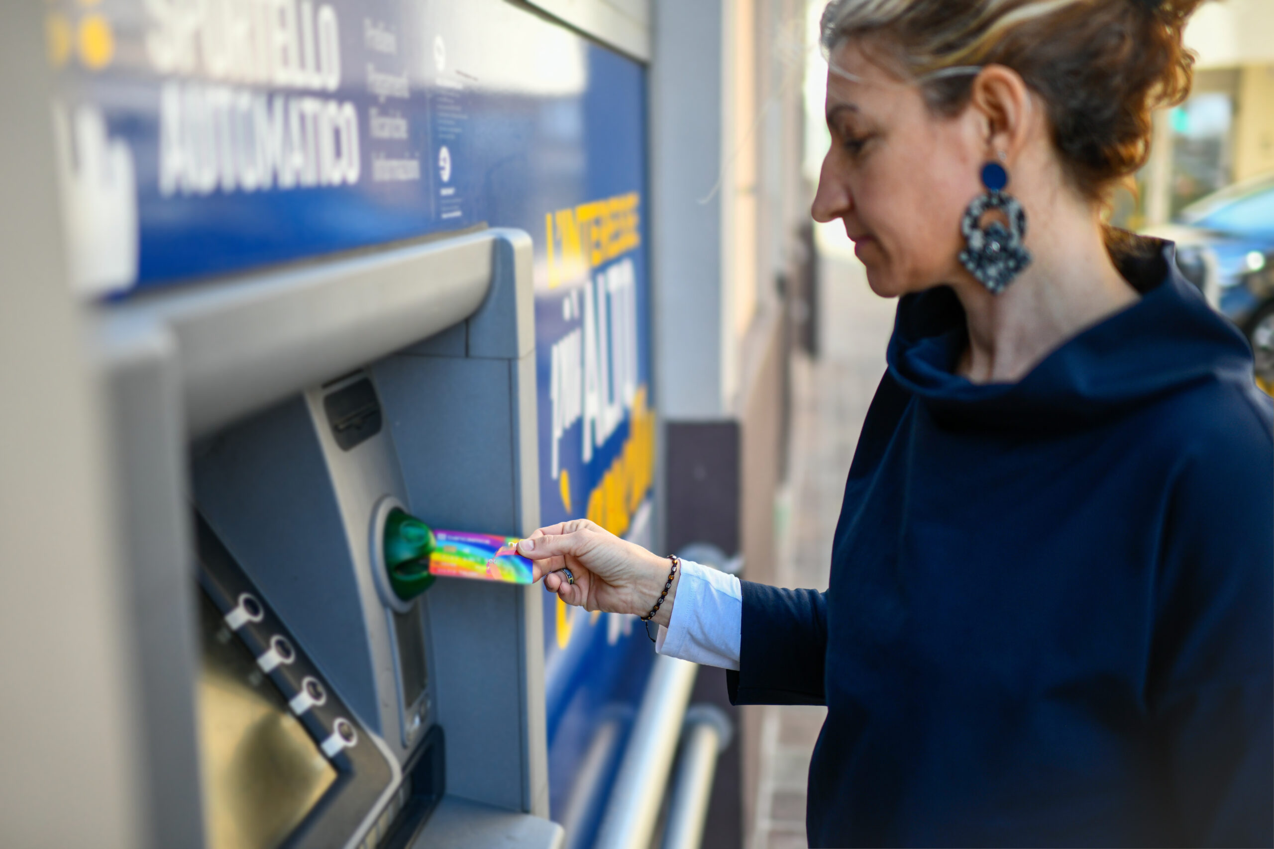 Ragazza con carta di debito allo sportello ATM